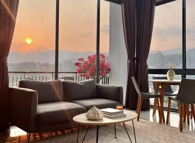 a living room with a couch and a table at Stylish penthouse with panoramic views at Icon Park in Kamala Beach