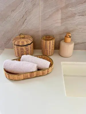 two baskets of towels and a vase on a counter at Stylish penthouse with panoramic views at Icon Park in Kamala Beach