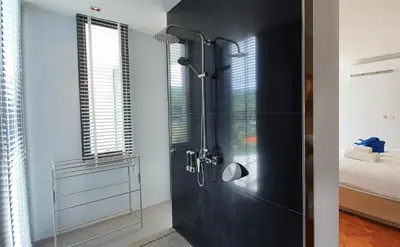 a bathroom with a shower with a glass door at Stylish penthouse with panoramic views at Icon Park in Kamala Beach