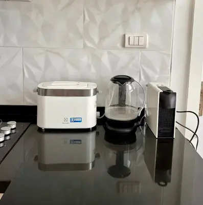 a counter top with a blender and a toaster at Stylish penthouse with panoramic views at Icon Park in Kamala Beach