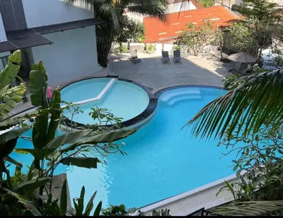a swimming pool in the middle of a house at Stylish penthouse with panoramic views at Icon Park in Kamala Beach