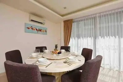 a dining room with a table and some chairs at Big Lucky home in Laguna park in Bang Tao Beach