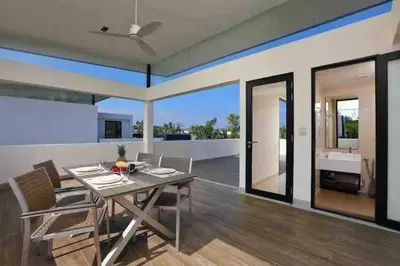 a dining room with a table and chairs at Big Lucky home in Laguna park in Bang Tao Beach