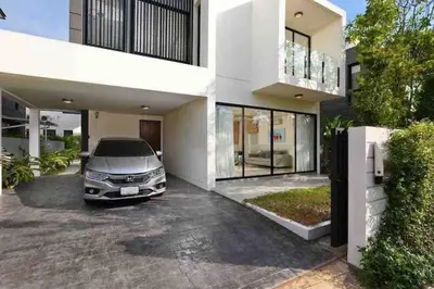 a car parked in the driveway of a house at Big Lucky home in Laguna park in Bang Tao Beach