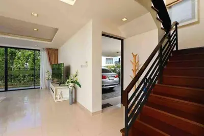 a living room with a staircase and a car parked in a driveway at Big Lucky home in Laguna park in Bang Tao Beach