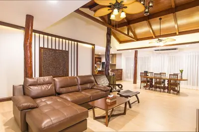 a living room with a leather couch and a table at Poonsiri Resort Aonang-SHA Extra Plus in Ao Nang Beach