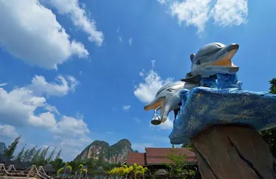 a statue of two dolphins on a rock at Poonsiri Resort Aonang-SHA Extra Plus in Ao Nang Beach