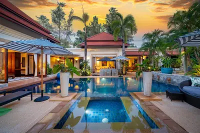 a house with a swimming pool in front of a house at Saitaan Villa Dennapa Bang Tao Beach in Bang Tao Beach