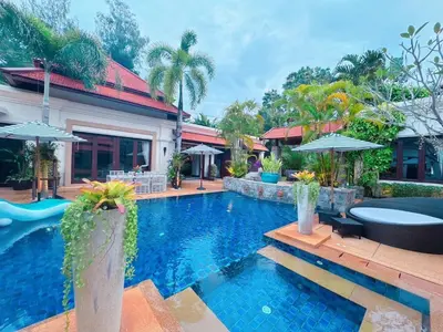 a swimming pool in front of a house at Saitaan Villa Dennapa Bang Tao Beach in Bang Tao Beach
