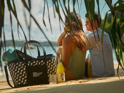 a man and a woman sitting on the beach at Casa Alma by Elite Havens in Nai Harn Beach