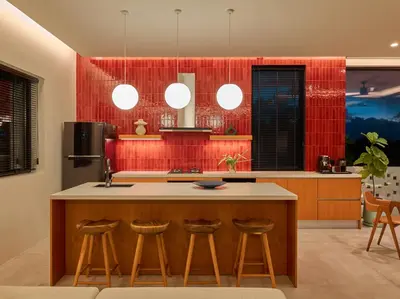 a kitchen with a island with bar stools at Casa Alma by Elite Havens in Nai Harn Beach