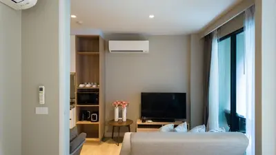 a living room with a bed and a television at Diamond Apartment with Terrace near Bang Tao Beach in Bang Tao Beach