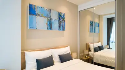 a bedroom with two beds and a mirror at Diamond Apartment with Terrace near Bang Tao Beach in Bang Tao Beach