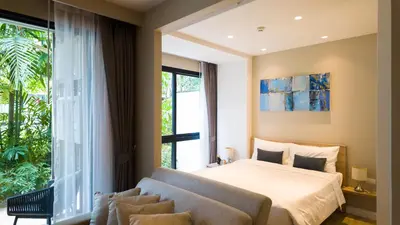 a bedroom with a bed and a large window at Diamond Apartment with Terrace near Bang Tao Beach in Bang Tao Beach