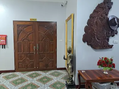 a room with a wooden door and a table and a table sidx sidx at Seaview Eagles Nest Apartments in Rawai Beach