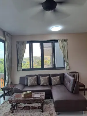 a living room with a couch and a table at Seaview Eagles Nest Apartments in Rawai Beach
