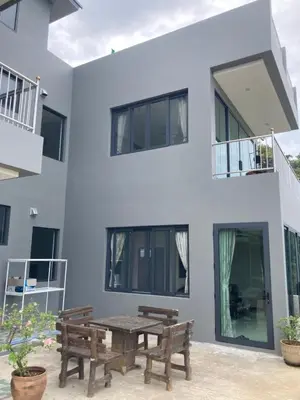 a house with a picnic table in front of it at Seaview Eagles Nest Apartments in Rawai Beach