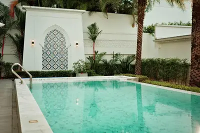 a swimming pool in front of a building at Menara - 3 BR Private Pool Villa - Moroccan Inspired - Bangtao Beach in Phuket Town