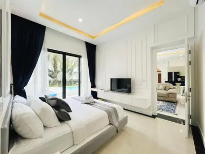 a bedroom with a large bed and a television at Menara - 3 BR Private Pool Villa - Moroccan Inspired - Bangtao Beach in Phuket Town