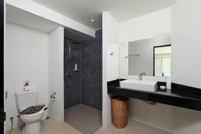 a bathroom with a sink and a toilet at Thaimond Residence by TropicLook Walkable distance to Naiharn beach in Nai Harn Beach
