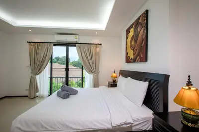 a bedroom with a white bed and a window at Thaimond Residence by TropicLook Walkable distance to Naiharn beach in Nai Harn Beach