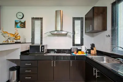 a kitchen with a sink and a counter top at Thaimond Residence by TropicLook Walkable distance to Naiharn beach in Nai Harn Beach