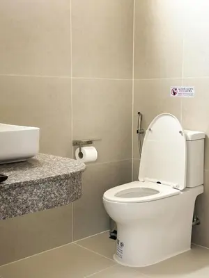 a bathroom with a white toilet and a sink at Botanic Boutique Hotel Surin Beach in Bang Tao Beach
