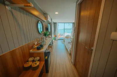 a room with a hallway with a row of shoes at Sea Sand See Sky Beach Front Resort in Phuket Town