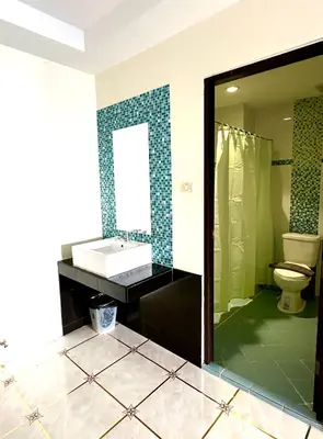 a bathroom with a sink and a toilet at Thai Classic House in Patong Beach
