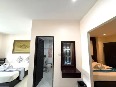 a hotel room with two beds and a bathroom at Thai Classic House in Patong Beach