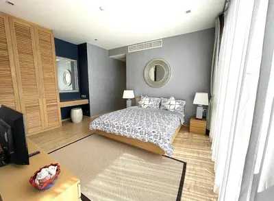 a bedroom with a bed and a mirror at Baan Mai Khao 3 Br in Phuket Town