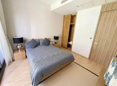 a bedroom with a large bed with blue pillows at Baan Mai Khao 3 Br in Phuket Town