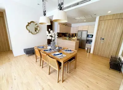 a kitchen and dining room with a table and chairs at Baan Mai Khao 3 Br in Phuket Town