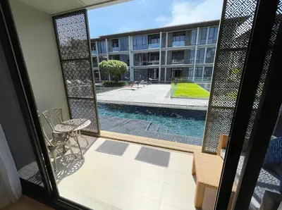 a view of a swimming pool from a window at Baan Mai Khao 3 Br in Phuket Town
