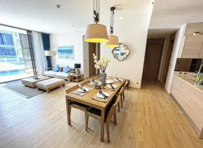 a living room with a table and a couch at Baan Mai Khao 3 Br in Phuket Town
