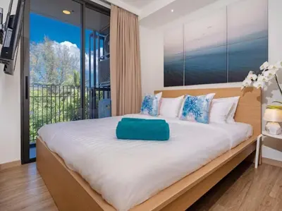a bedroom with a large bed with a large window at 2 спальни Апартаменты на Бангтао 600 метров от моря in Bang Tao Beach