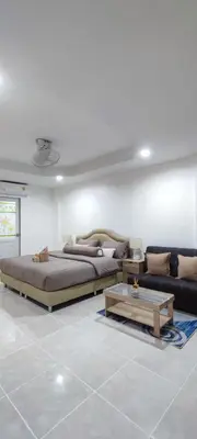 a living room with two beds and a couch at Sleep tight Patong in Patong Beach