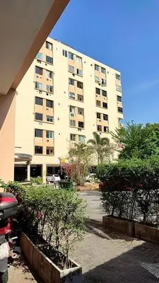 a large building with a parking lot in front of it at Sleep tight Patong in Patong Beach