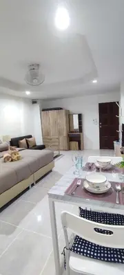 a living room with a couch and a table at Sleep tight Patong in Patong Beach