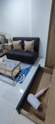 a living room with a couch and a table at Sleep tight Patong in Patong Beach