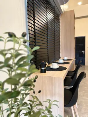 a row of tables and chairs in a room with plants at Gloria’s Home in Kamala Beach