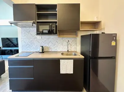 a kitchen with a sink and a refrigerator at Gloria’s Home in Kamala Beach