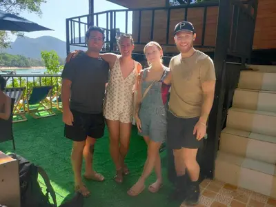 a group of four people posing for a picture at Sweed Dee Seaview Hostel in Phi Phi Don