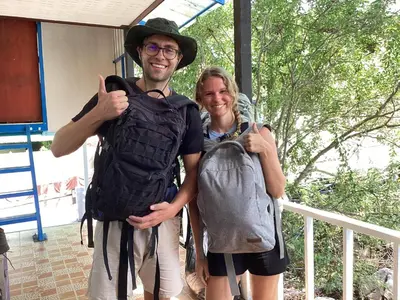 a man and a woman posing for a picture with a backpack at Sweed Dee Seaview Hostel in Phi Phi Don