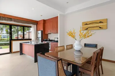 a kitchen and dining room with a vase on a table at Laguna Lakeview Villa in Layan Beach