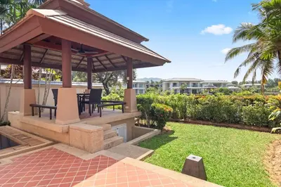 a gazebo with a table and chairs in a yard at Laguna Lakeview Villa in Layan Beach