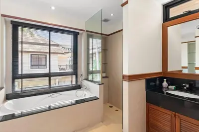 a bathroom with a large tub and a window at Laguna Lakeview Villa in Layan Beach