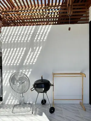 a grill and a fan in front of a white wall at 2BR Pool Villa&Garden - Bali style by La Perla Phuket Rawai in Ban Saiyuan (1)