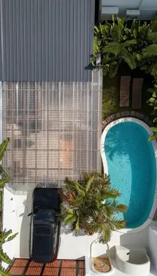 a car parked next to a pool in a building at 2BR Pool Villa&Garden - Bali style by La Perla Phuket Rawai in Ban Saiyuan (1)