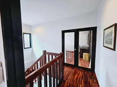 a staircase with a glass door in a house at KRAAM VILLAS in Thalang